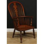 A 19th century country house elm Windsor elbow chair, hoop back, shaped and pierced splat, bowed mid
