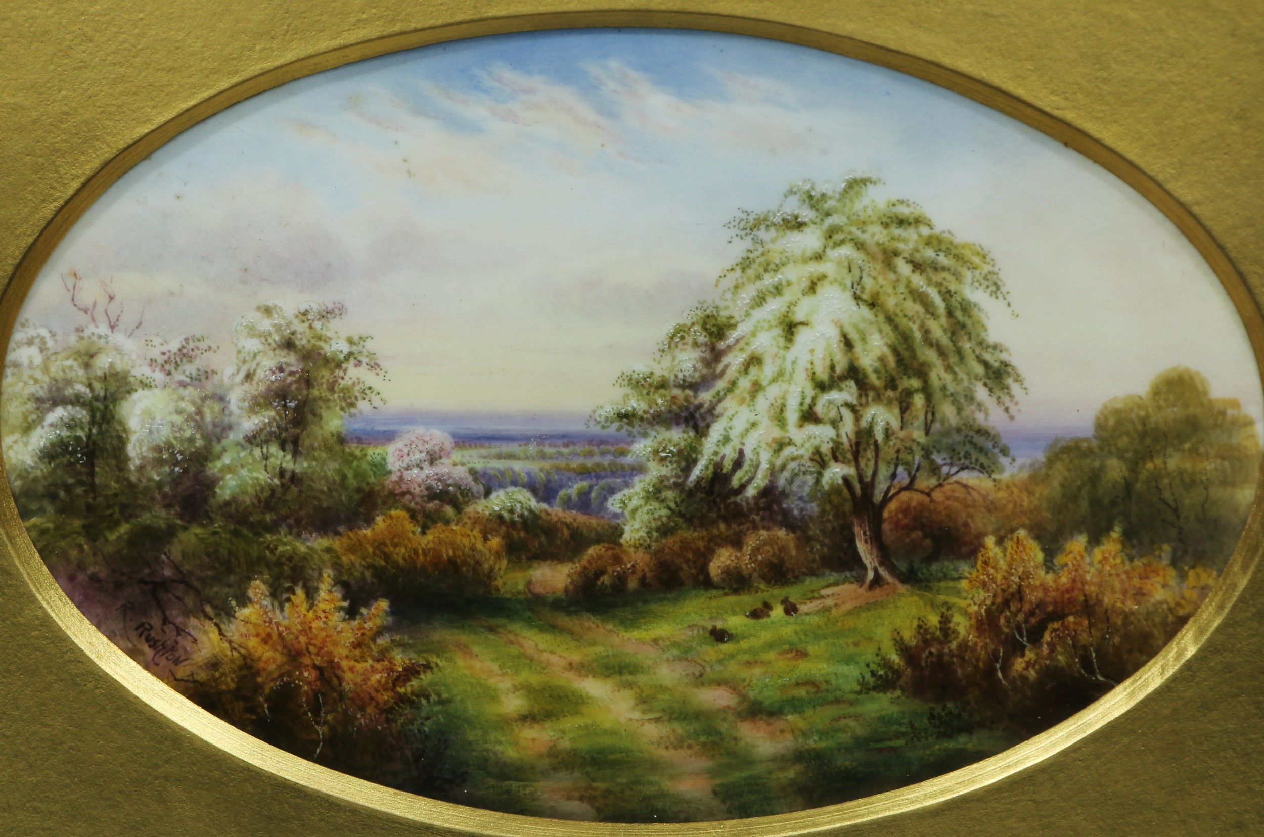 A Royal Worcester oval plaque painted by Raymond Rushton, signed, with rabbits grazing in blooming