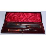 An Edwardian silver mounted three piece carving set, stag antler handles, the knife 38cm long,