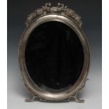 A large Russian Empire silver plated oval easel dressing table mirror, surmounted by a buckled