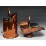 A 19th century copper fuel bun, swing handle, skirted base, 43cm high, c.1880; another, helmet