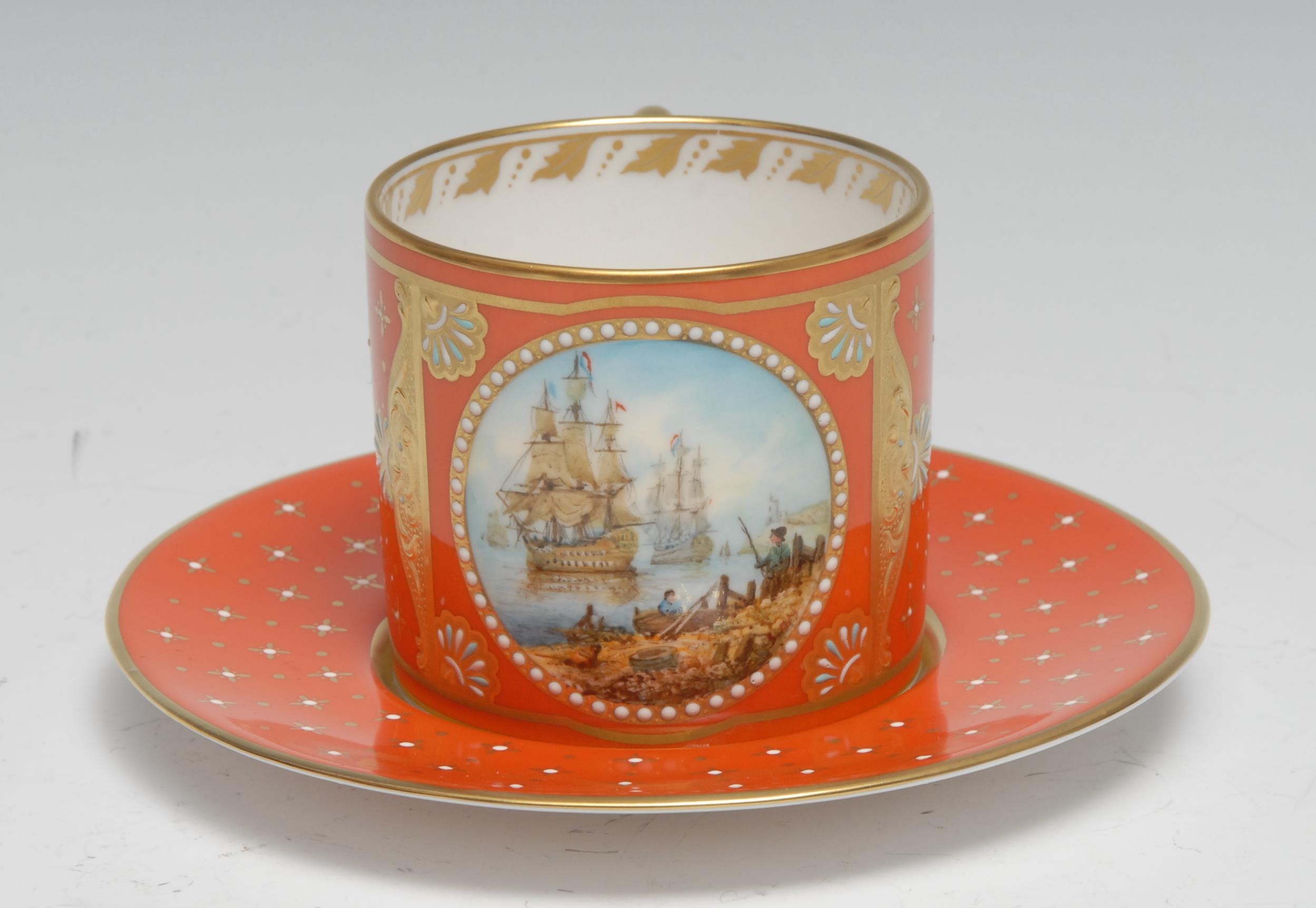 A Lynton porcelain coffee can and stand, painted by Stefan Nowacki, monogrammed, with a Dutch