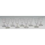 A set of nine early 19th century wine glasses, the bowls etched with fruiting vine, folded foot, 9.