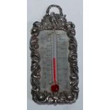 A George IV silver travelling thermometer, the flowerhead and leafy scroll border crested by birds