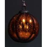 A late 19th/early 20th century iridescent orange lobed glass witches ball, metal hanging pendant,