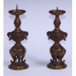 A pair of Japanese gilt bronze pricket candlesticks, cast with temple lion masks, birds and blossom,