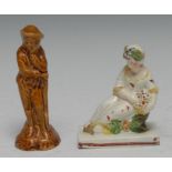 A Staffordshire figure, a lady reclining, with floral chaplet, holding a basket of flowers, 9.5cm
