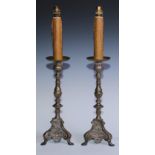 A pair of French Baroque silvered brass candlesticks, of seamed construction, later fitted for