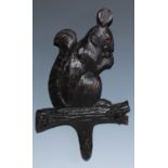 A Black Forest novelty coat hook, carved as a squirrel, glass eyes, 35.5cm long, c.1900