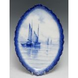 A Royal Crown Derby oval plaque, painted by WEJ Dean, with ships on calm waters, in tones of blue,