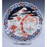 A Japanese Imari charger decorated with a fanciful bird, cranes and flowering prunus within panelled