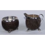 A 19th century Colonial silver mounted coconut jug and bowl, probably Indian, carved in relief