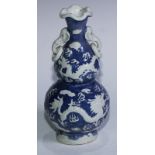 A Chinese double gourd vase, moulded in relief with dragons and phoenix amongst clouds, elephant