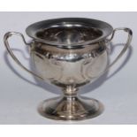 An Arts and Crafts silver two-handled pedestal bowl, chased in the Art Nouveau taste with stylised