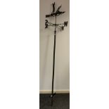 A metal-work Weather-vane, the figure/ornament depicting a Golfer teeing off, 242cm tall.