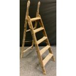 A 'Self Acting Stop' folding wooden step ladder