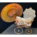 A 20th century Victorian style dolls pram; a parasol; etc