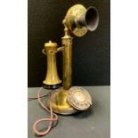 An early 20th century Leich Brass candlestick telephone, silvered dial, bakolite mouth piece,