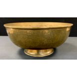 A large Chinese polished brass bowl, engraved with prunus and floral panels, 31cm diameter.