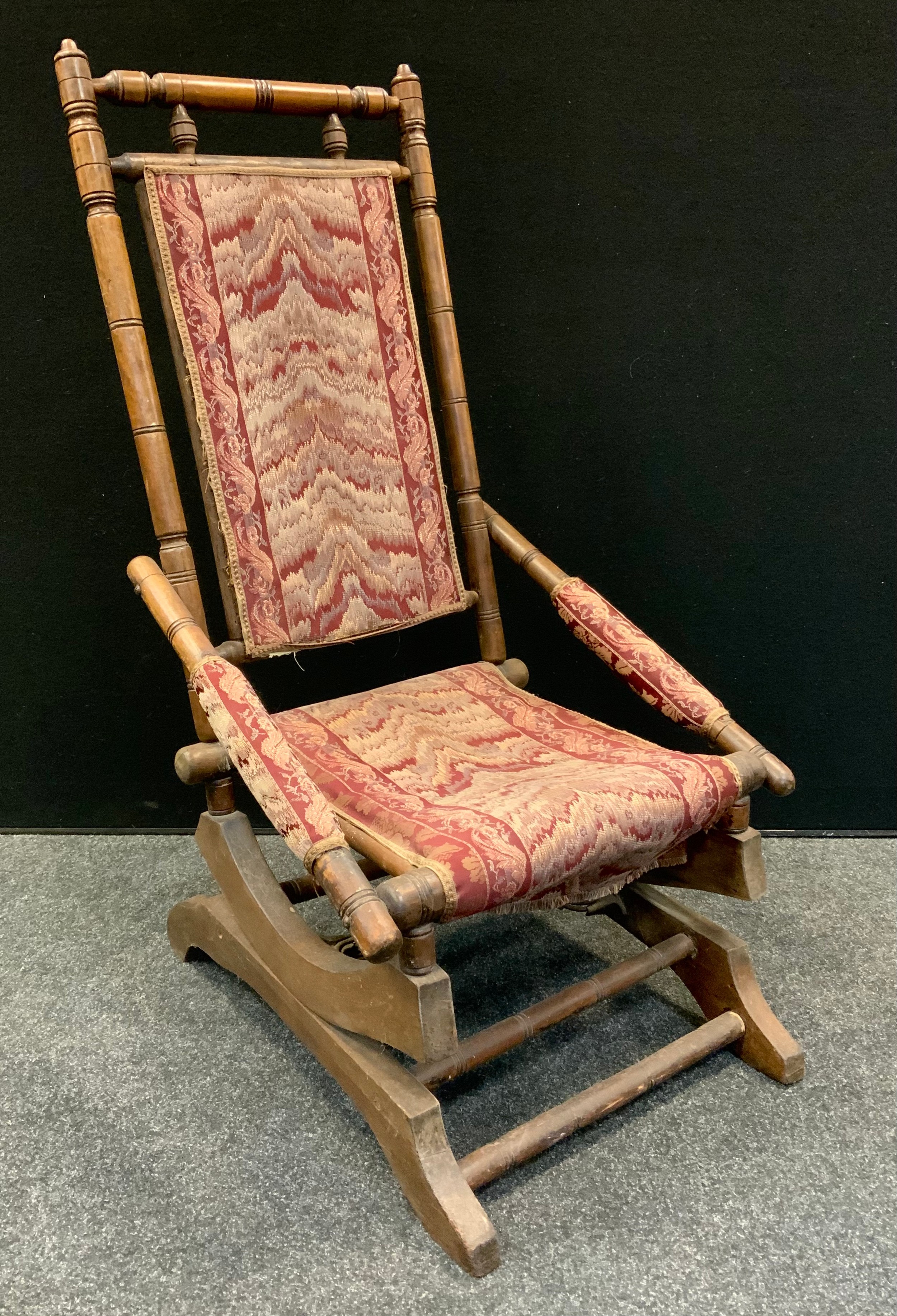 An early 20th century 'American' spring rocking chair, 105cm high, 54cm wide, the seat 38cm wide and