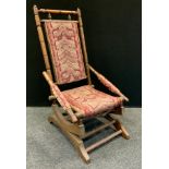 An early 20th century 'American' spring rocking chair, 105cm high, 54cm wide, the seat 38cm wide and