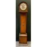 An early 20th century oak longcase clock of small proportions, arched case, the silvered dial with