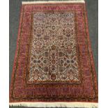 A fine, hand-made Kashan rug / carpet, the margin of deep red and blue enclosing a central field