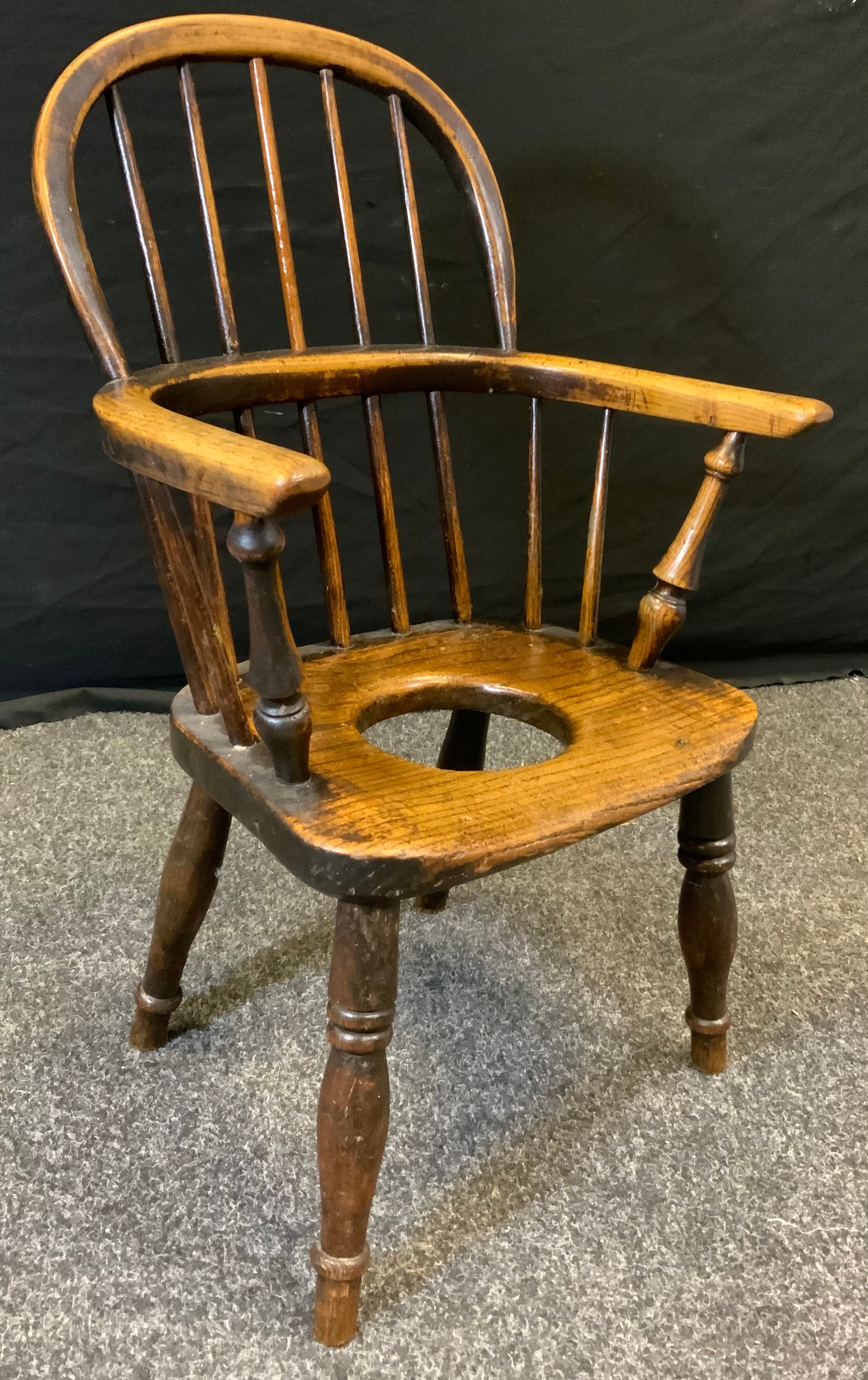 An early 19th century child's, oak and elm, commode Windsor chair, c.1800.