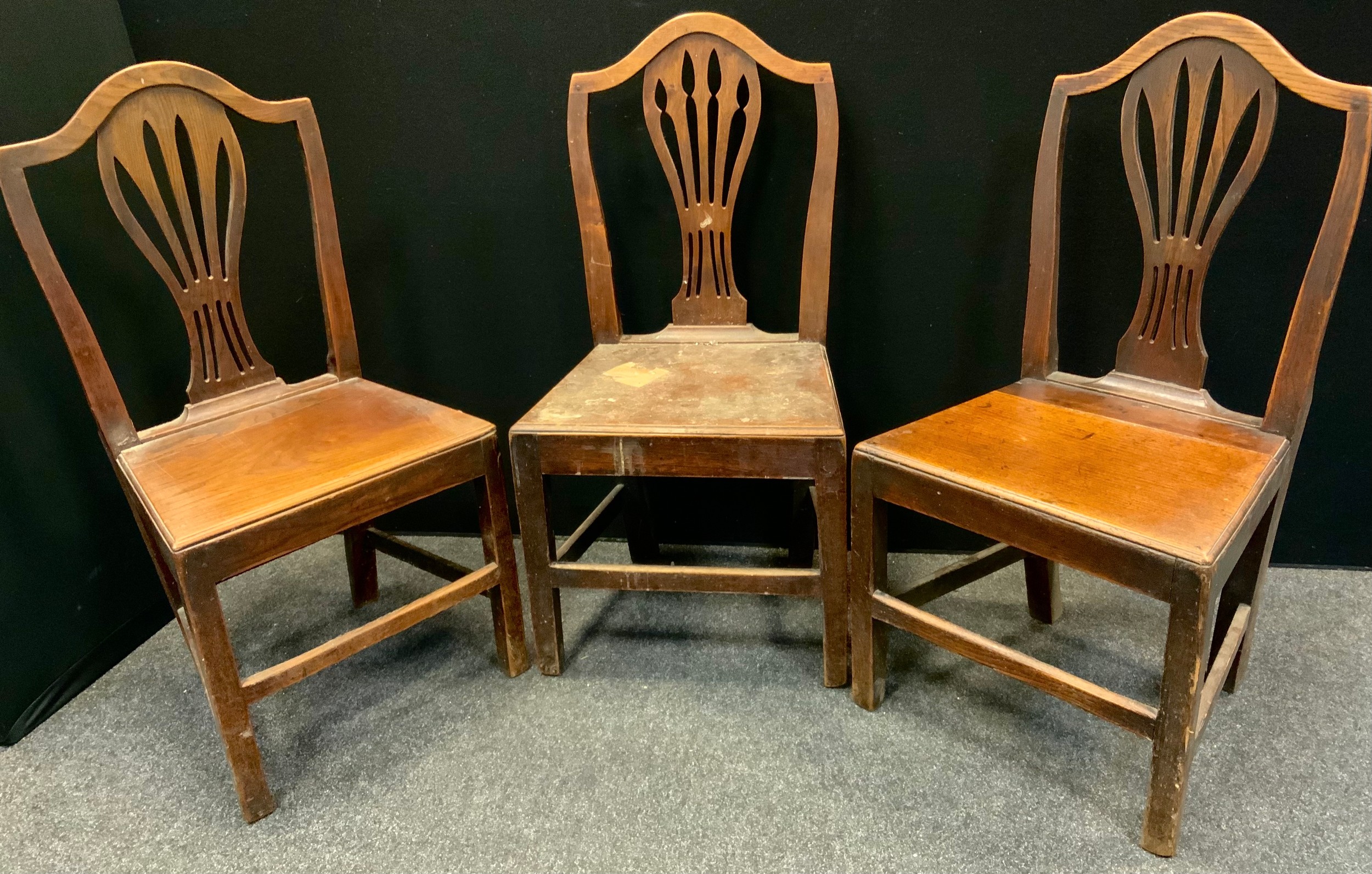 A pair of early 19th century oak and elm chairs, arched top, pierced vasular splat, square legs