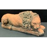 A Terracotta coloured figure Sleeping Lion,14cm high, 31cm long, 10.5cm wide