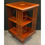 An Edwardian mahogany revolving bookcase, inlaid patara to top, satinwood banding, and boxwood