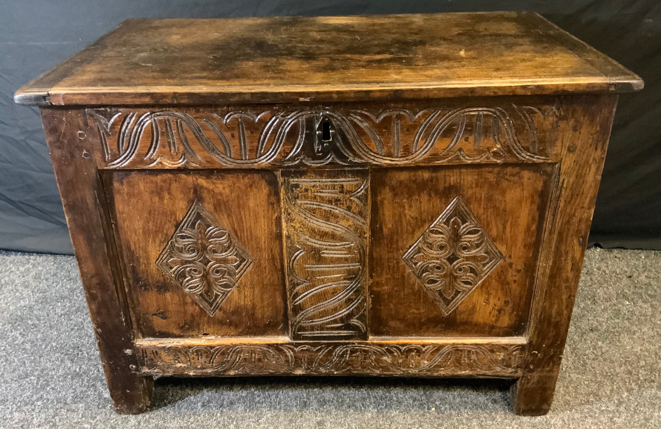 A 18/early 19th century oak blanket chest, hinged top, two paneled carved front, 56cm high, 76cm - Image 2 of 2