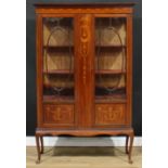 An Edwardian mahogany and marquetry display cabinet, outswept cornice above a pair of doors