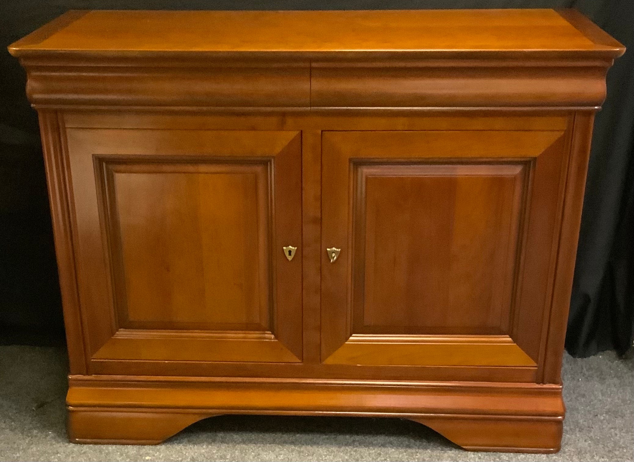 A contemporary Ernest Menard mahogany sideboard, rounded rectangular top above a pair of long