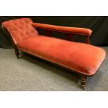 A Victorian mahogany chaise lounge, upholstered in pink, turned gallery and supports,