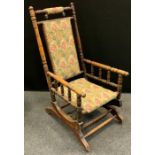 An early 20th century 'American' spring rocking chair, 104.5cm high, 56cm wide, the seat 40cm wide