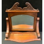 A Victorian dressing table mirror, carved crest and supports, serpentine front, arched bevelled