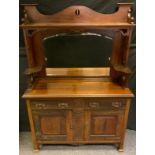 An Arts and Crafts mahogany sideboard, shaped arch cresting above a bevelled arch rectangular