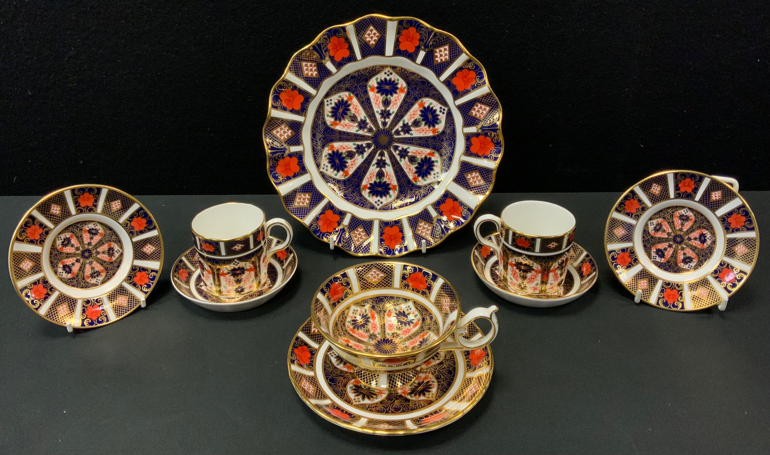 A Royal Crown Derby 1125 pattern pedestal cups and saucer; two similar coffee cans and saucers;