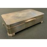 An At Deco style silver canted rectangular desk top cigarette box, S J Rose & Son, London 1961,