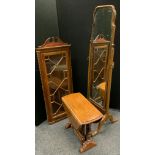 An early 20th century mahogany cheval dressing mirror, 157cm tall; a wall mounted corner cabinet
