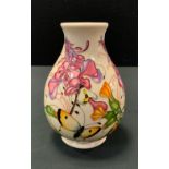 A Moorcroft pottery baluster vase decorated in the Family Through Flowers pattern, painted and