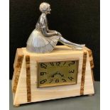 A French Art Deco figural mantle clock, white onyx and marble canted rectangular case with chromed