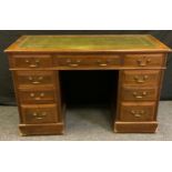 A late Victorian oak twin pedestal desk, rectangular top above three frieze drawers, three further