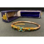 An early 20th century rose coloured metal turquoise inset hollow bar hinge bangle, unmarked, 7g