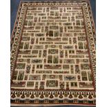 A 20th century Egyptian carpet / rug woven with scarabs and stylised animals in muted tones of