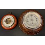 A carved oak framed aneroid barometer, another smaller plain (2)