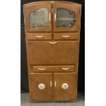 A 1940s Numaid kitchen unit, a pair of glazed doors above a fall front enclosing shelves and small