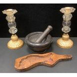 A 19th century wooden butter press as a stylized fish; a deep grey stone pestle and mortar, a pair