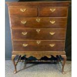 A George III oak chest on stand, rectangular top above two short and three long graduated drawers,